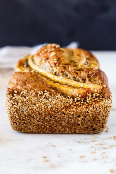 Here's a healthy, delicious recipe for Banana Bread with a toasty Sesame Seed Crust. Infused with ginger, it's moist and flavorful. Vegan-adaptable, and can be made with sourdough starter.