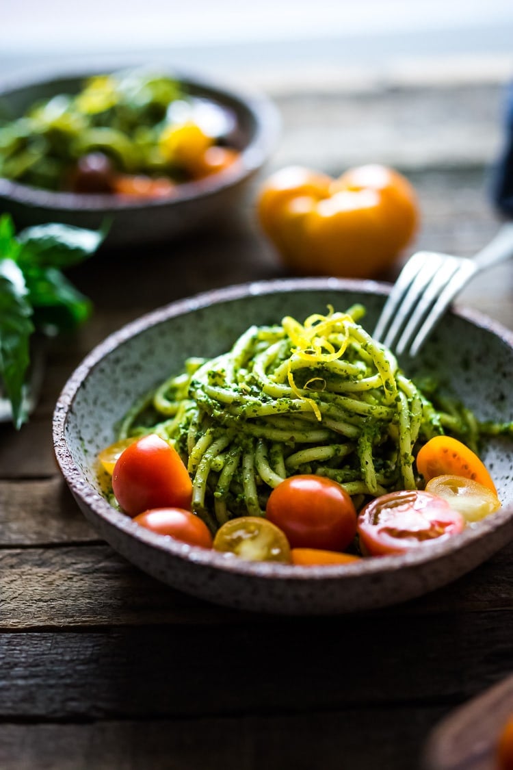40 Mouthwatering Vegan Dinner Recipes!| Bucatini Pasta with Arugula Pesto and Heirloom Tomatoes. A fast and flavorful weeknight dinner recipe. This Healthy pasta is Vegan! #bucatini #bucatinipasta #pastawithpesto #arugulapesto www.feastingathome.com