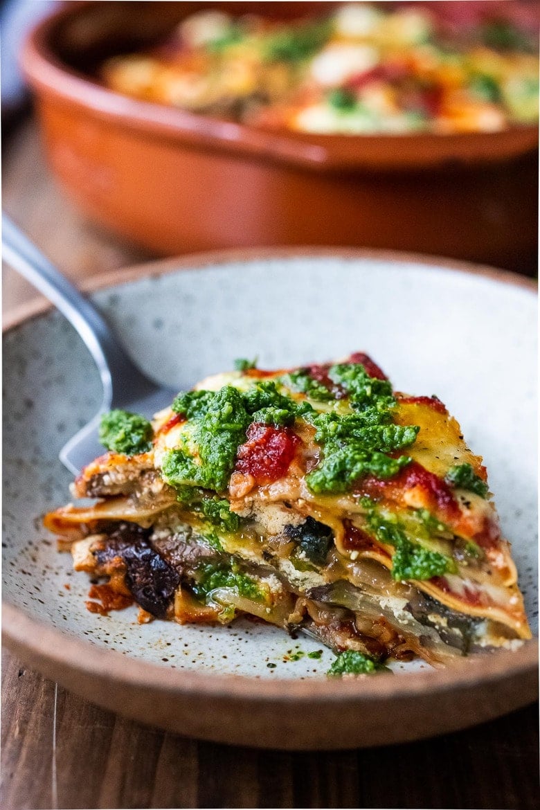 Easy Eggplant Lasagna made with no-boil noodles and topped with Arugula Pesto. A delicious, healthy vegetarian dinner recipe that is comforting and nourishing. #vegetarian #eggplantlasagna #lasagna #healthycomefortfood