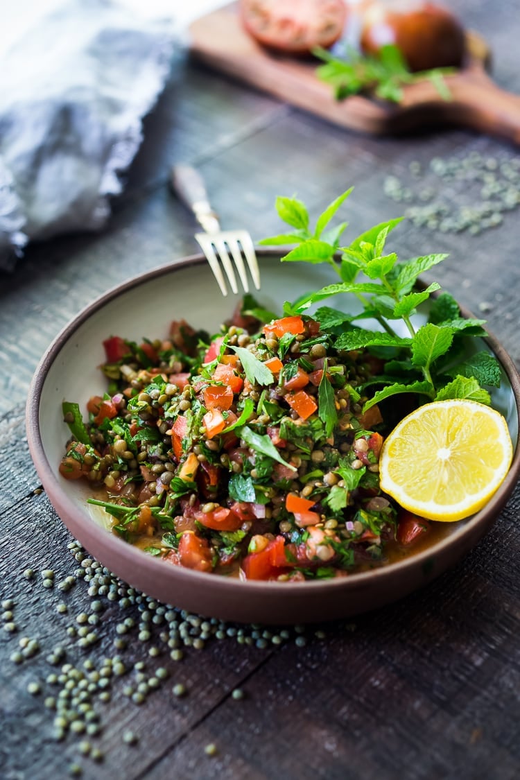 25 Best Lentil Recipes! | This Simple Lentil Tabouli Salad is full of Middle Eastern flavor! Filling lentils are paired with summer  tomatoes, lemon, mint and parsley and a unique combination of spices, and keeps for several days, perfect for midweek lunches or potlucks! Vegan and Gluten-Free #tabouli #lentil #lentils #lentilsalad #lentiltabouli #lentiltabbouleh #tabbouleh #vegan #salad #glutenfree