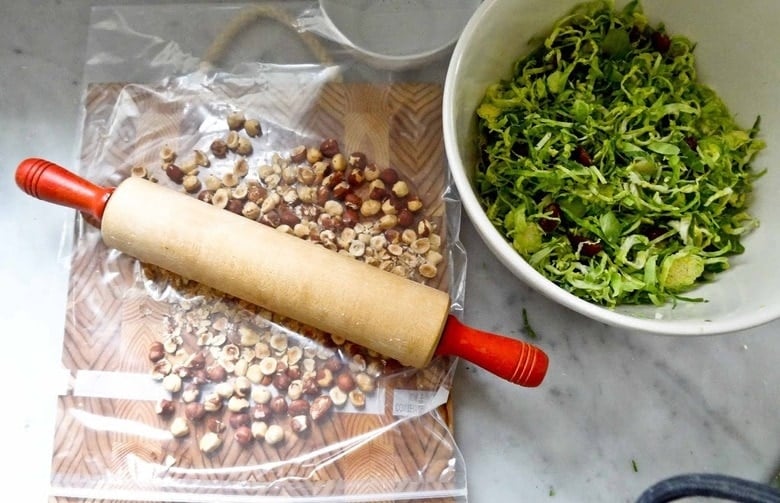 Hazelnuts in a plastic bag with a rolling pin.