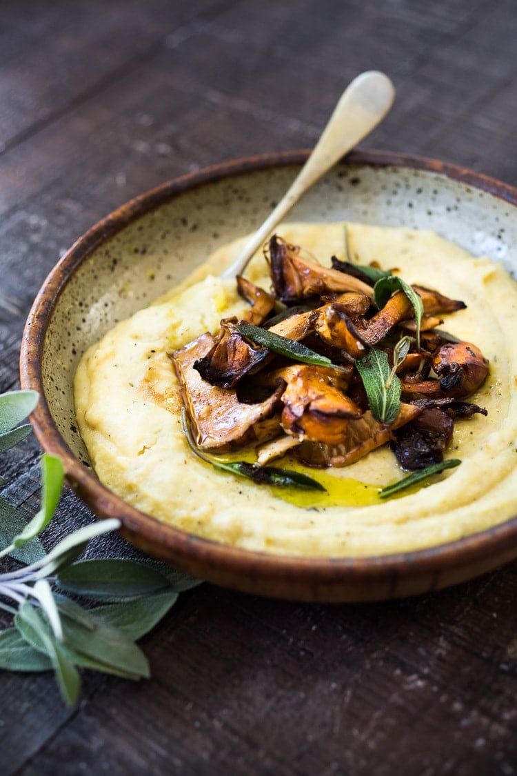 Creamy Polenta with Wild Mushrooms, Garlic and Sage. A simple EASY dinner that can be made in under 30 minutes. Comfort food that is healthy, vegan adaptable and gluten-free! | #polenta #creamypolenta #mushrooms #morels #chanterelles #mushroompolenta #polenta #vegan 