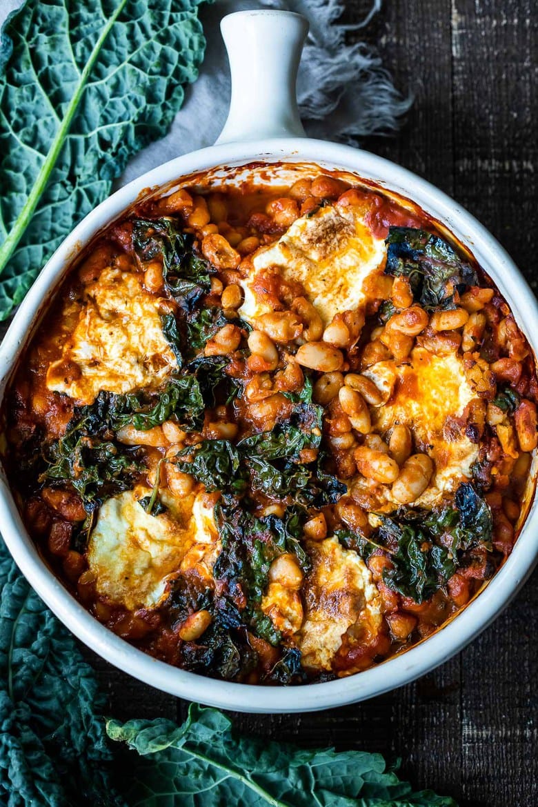 Italian Baked Beans, made with cannellini beans, kale, and your favorite homemade (or store-bought) Marinara sauce, and baked in the oven until golden and bubbling. A delicious vegetarian main!
