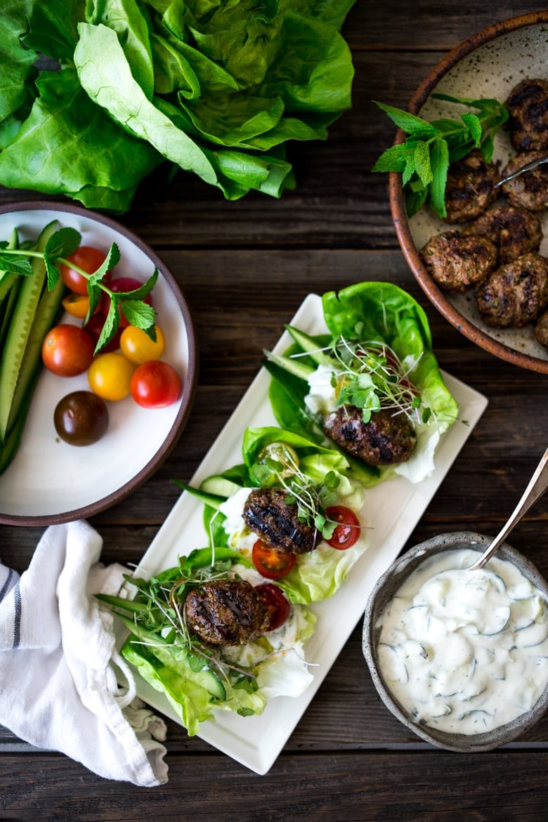 Grilled Lamb Kofta Wraps are light and delicious, and BURSTING with Middle Eastern Flavor! Served with Tzatziki, these are low carb and high in protein.