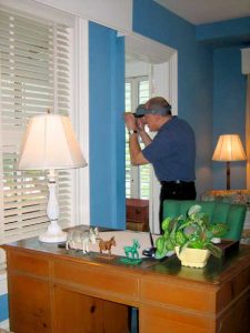 Matthew Mosca sampling the paint on the walls of the Little White House.