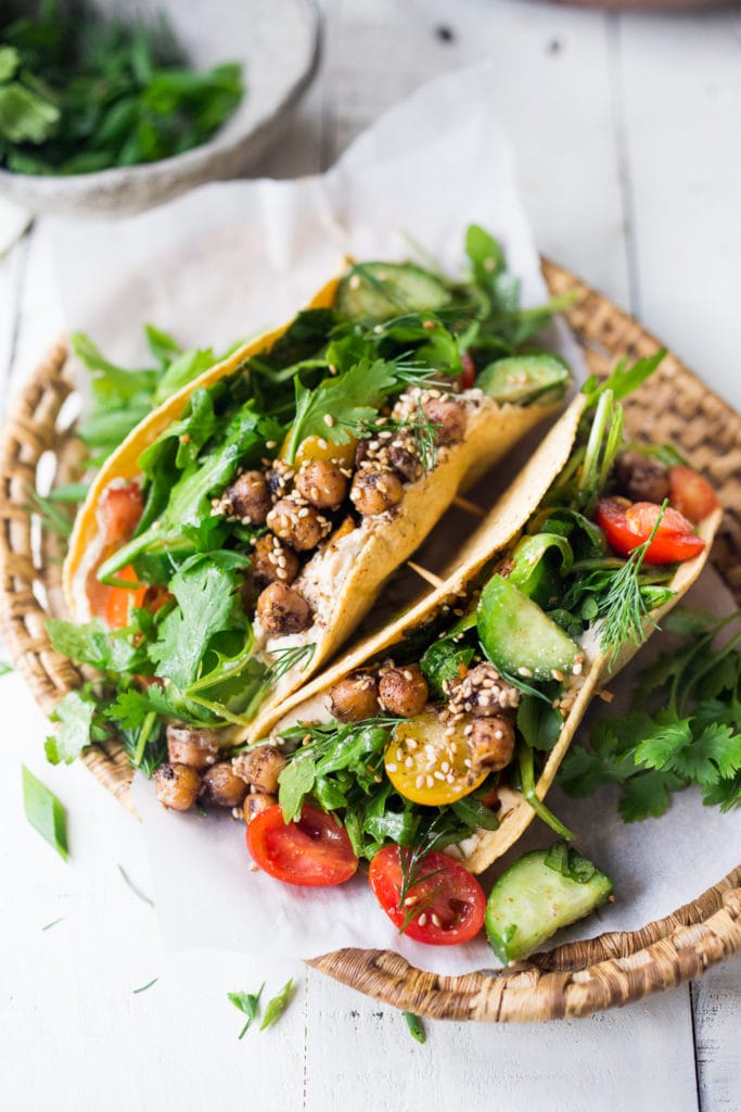 Middle Eastern Salad Tacos with spiced chickpeas, hummus and a mound of lemony salad, topped with fresh herbs and scallions. Vegan & sooooo Delicious! | www.feastingathome.com