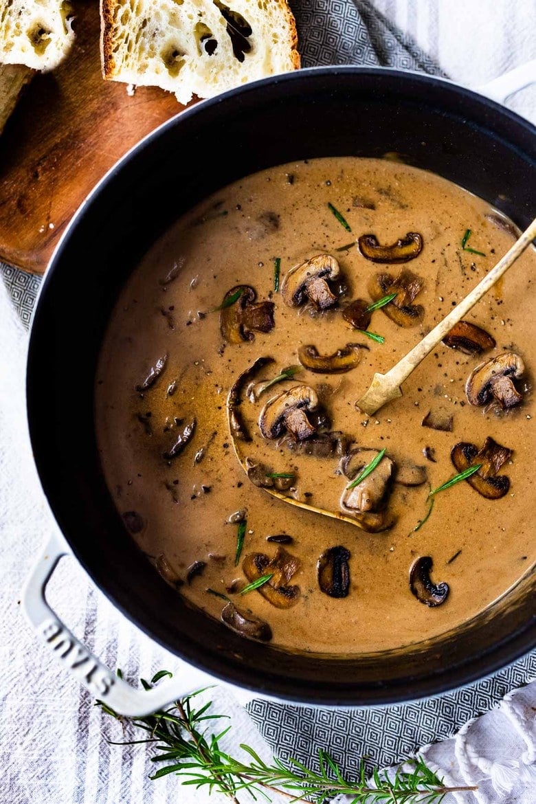 Creamy Mushroom Soup with Rosemary and Garlic - a delicious easy recipe that is Keto friendly and perfect for special  gatherings or simple enough for weeknight dinners! Serve this with crusty bread for a simple hearty meal!  #mushroomsoup #mushroomsouprecipe #mushroomrecipes #ketosoup