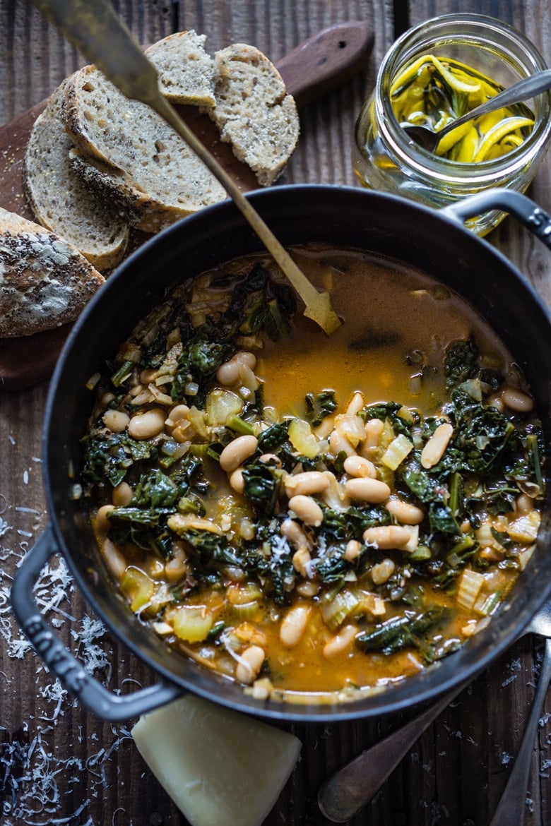 20 Vegetarian Soups to Savor Now -this flavorful hearty stew from Tuscany, is called Ribollita with Cannellini beans, lacinato kale, and vegetables, served with crusty bread, drizzled with a Lemon Rosemary Garlic Oil. | www.feastingathome.com