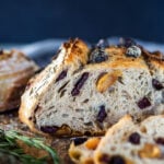 How to make Crusty Sourdough Bread, infused with rosemary, roasted garlic and olives that requires no kneading and rises overnight. Made with sourdough starter instead of yeast! #sourdoughbread