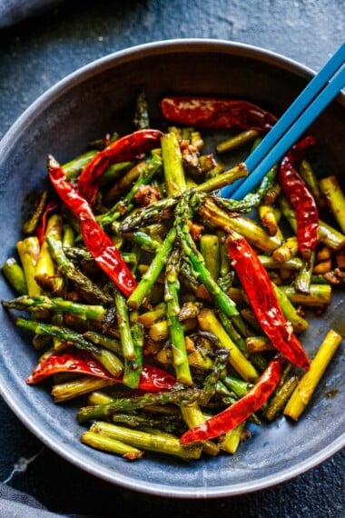 This Szechuan Asparagus is one of our favorite ways to cook asparagus! Fast, easy and full of so much flavor. Vegan!