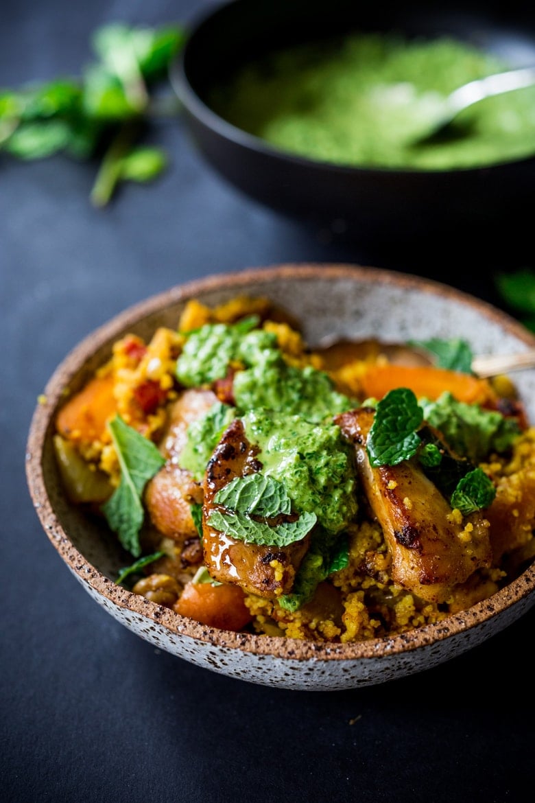 A delicious Tunisian-inspired Chicken Tagine (or sub chickpeas) with couscous, carrots, and flavorful Green Harissa Sauce. A one-pan meal that can be made in 45 minutes! Vegan and Gluten-free adaptable! 