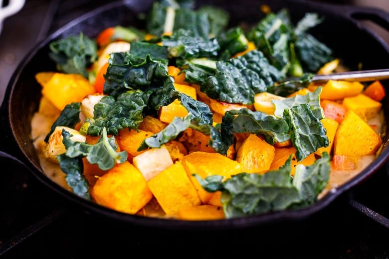 Folding in the roasted veggies and kale into the stew base