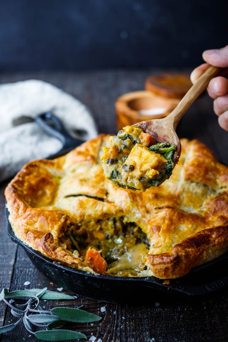 Veggie Pot Pie with roasted butternut squash, lentils, and kale, topped with a golden puff pastry crust- a cozy vegan dinner recipe the whole family will enjoy. 