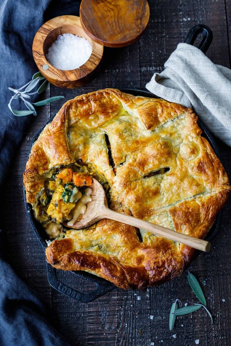 Vegetable Pot Pie with roasted butternut squash, lentils, and kale, topped with a golden puff pastry crust- a cozy vegan dinner recipe the whole family will enjoy. 