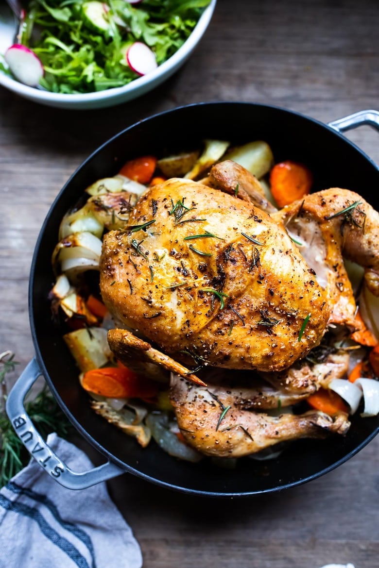 30 Fall Dinner Ideas! A simple easy recipe for roast chicken with lemon, garlic and rosemary, baked in the oven over vegetables. A delicious dinner recipe! #roastchicken